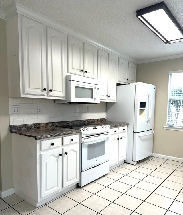 kitchen featuring white cabinetry, sink, white appliances, and light tile patterned floors