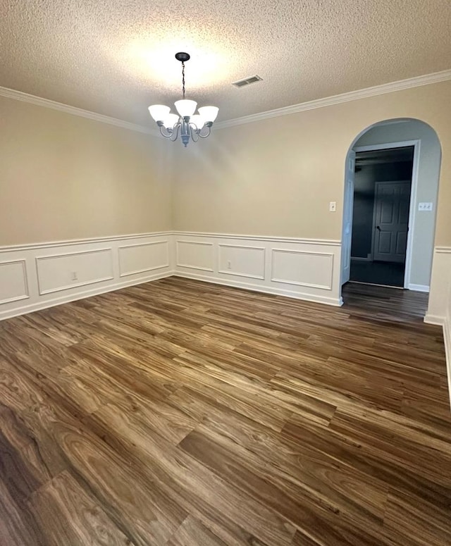 unfurnished dining area featuring dark hardwood / wood-style floors, a notable chandelier, and a textured ceiling