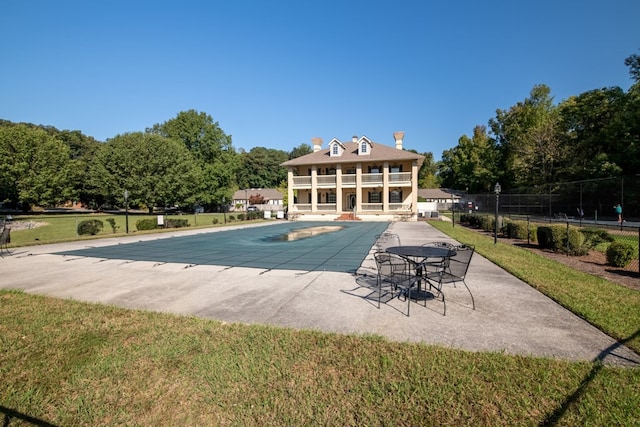 view of pool featuring a lawn and a patio area