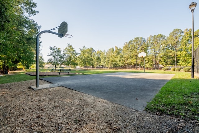 view of sport court featuring a yard