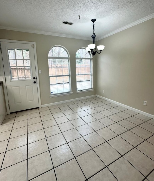 unfurnished dining area with an inviting chandelier, ornamental molding, and a textured ceiling