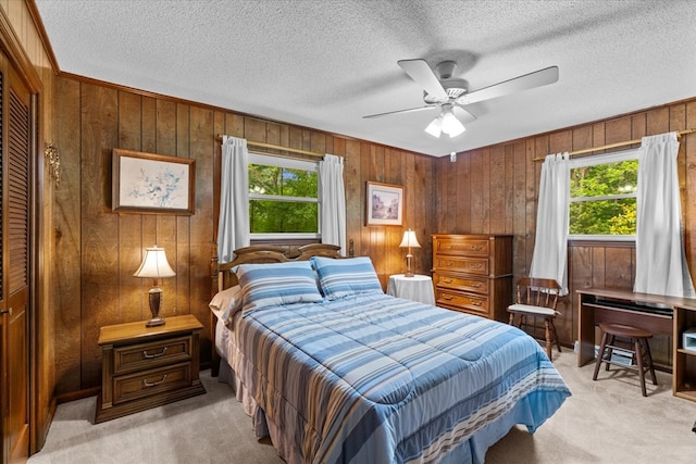 3932 Tibbs Bridge Rd, Dalton, GA 30721 - bedroom with light carpet, multiple windows, wooden walls, a textured ceiling, and a ceiling fan