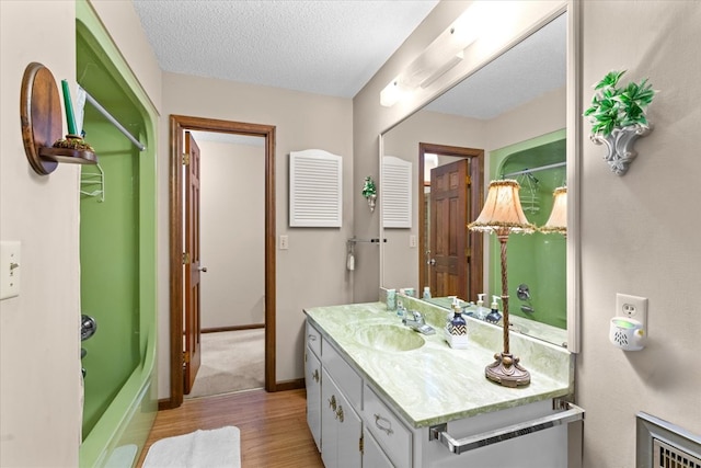 3932 Tibbs Bridge Rd, Dalton, GA 30721 - full bathroom with vanity, wood finished floors, and a textured ceiling