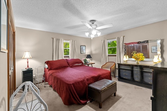 3932 Tibbs Bridge Rd, Dalton, GA 30721 - bedroom with multiple windows, light colored carpet, a textured ceiling, and ceiling fan