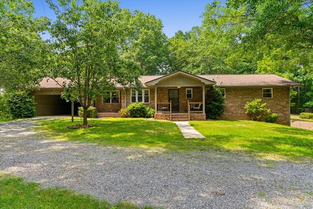 3932 Tibbs Bridge Rd, Dalton, GA 30721 - ranch-style house with a porch, gravel driveway, a front yard, and brick siding