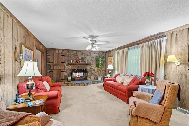 3932 Tibbs Bridge Rd, Dalton, GA 30721 - carpeted living area with wood walls, ceiling fan, a textured ceiling, and a stone fireplace
