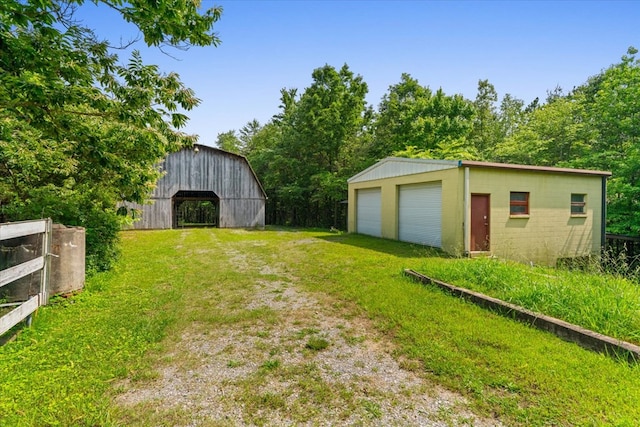 3932 Tibbs Bridge Rd, Dalton, GA 30721 - view of grassy yard featuring an outdoor structure, a detached garage, and a barn