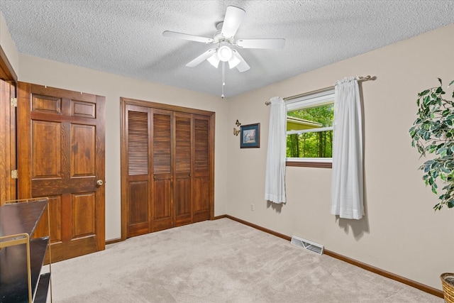 3932 Tibbs Bridge Rd, Dalton, GA 30721 - unfurnished bedroom featuring a textured ceiling, a closet, carpet floors, and a ceiling fan