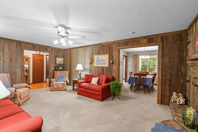 3932 Tibbs Bridge Rd, Dalton, GA 30721 - carpeted living room featuring wooden walls, a textured ceiling, a chandelier, and ceiling fan