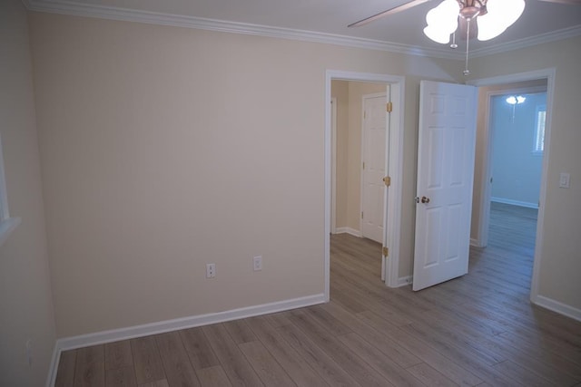 spare room featuring ceiling fan, ornamental molding, and light hardwood / wood-style floors