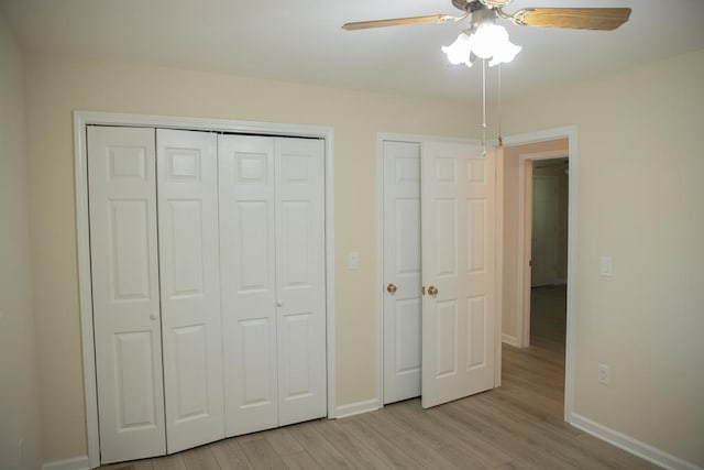 unfurnished bedroom featuring ceiling fan, light hardwood / wood-style floors, and a closet