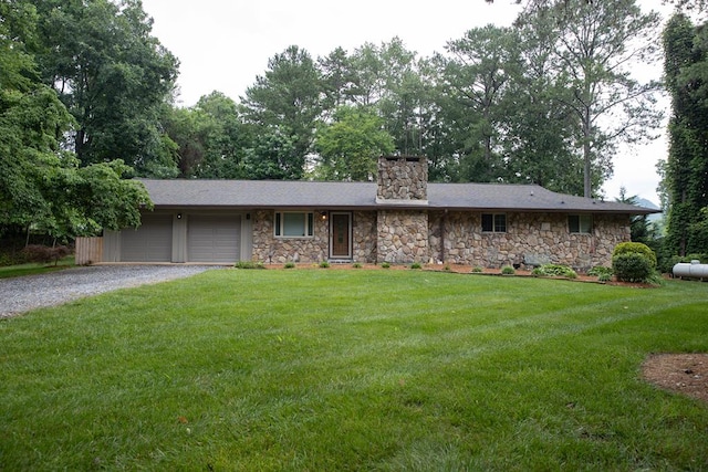 ranch-style home featuring a garage and a front lawn