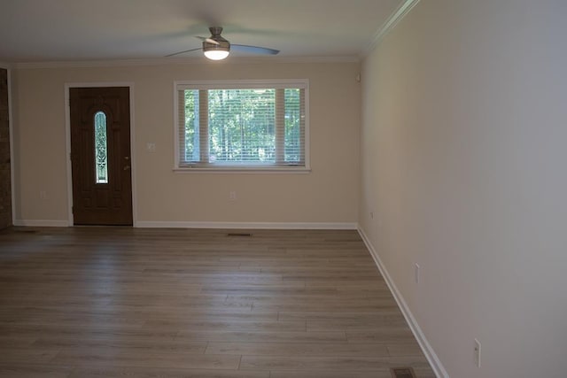 empty room featuring ornamental molding, ceiling fan, and light hardwood / wood-style floors