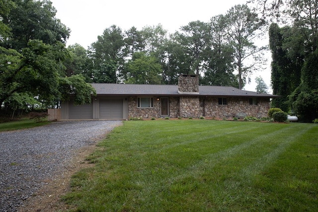 single story home featuring a garage and a front lawn