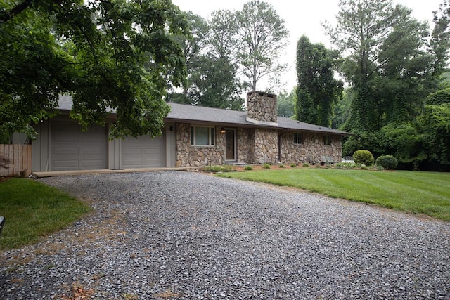 single story home with a garage and a front yard