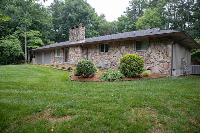 rear view of property featuring a yard and a garage