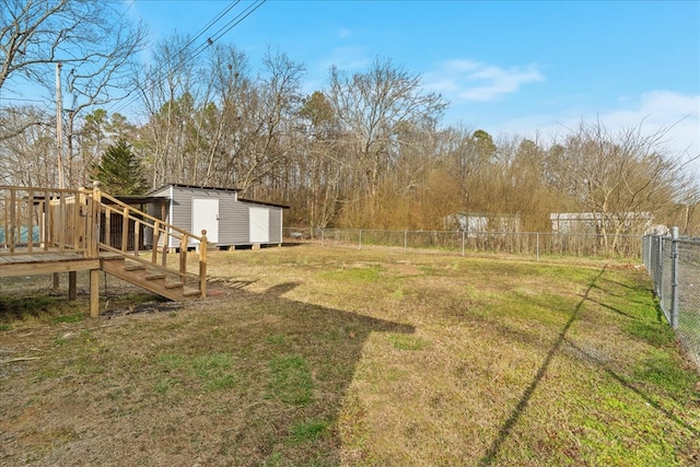 view of yard with an outdoor structure, fence, and a shed