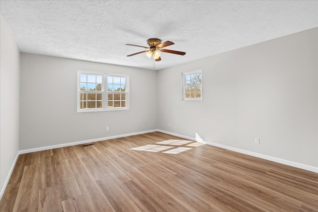 spare room featuring baseboards and wood finished floors