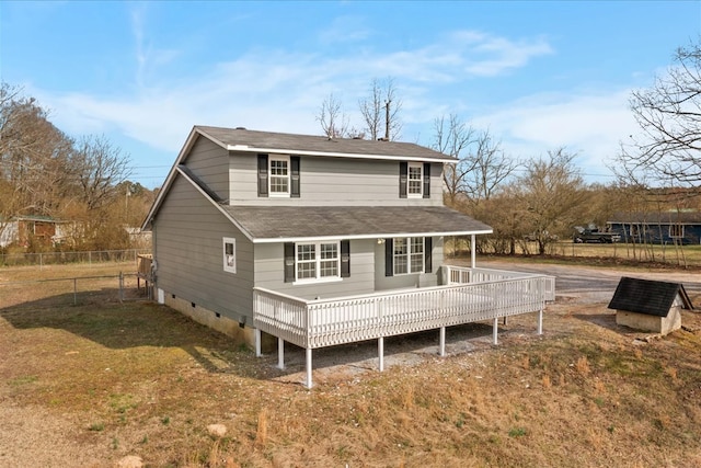 back of property with fence, a lawn, roof with shingles, and crawl space