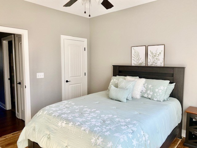 bedroom with a ceiling fan and wood finished floors