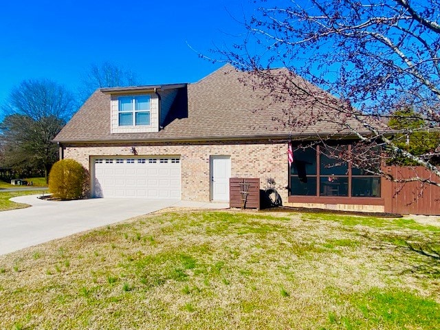 view of property exterior with a garage, a yard, concrete driveway, and brick siding