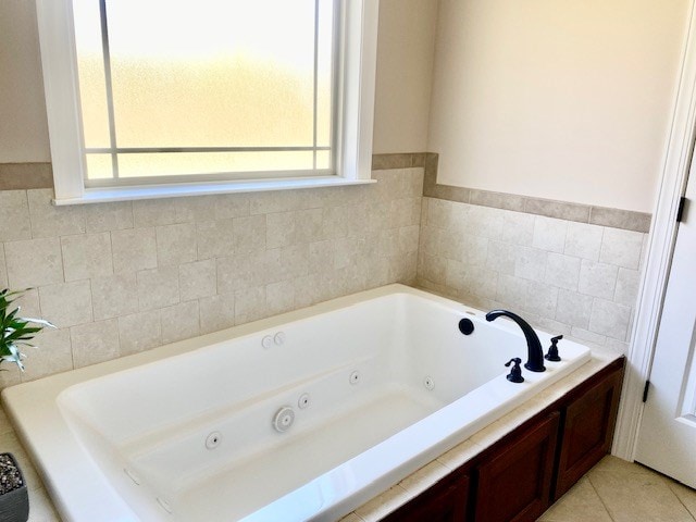 bathroom with a whirlpool tub and tile patterned floors