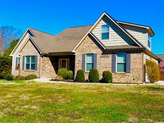 view of front of house featuring a front lawn and brick siding