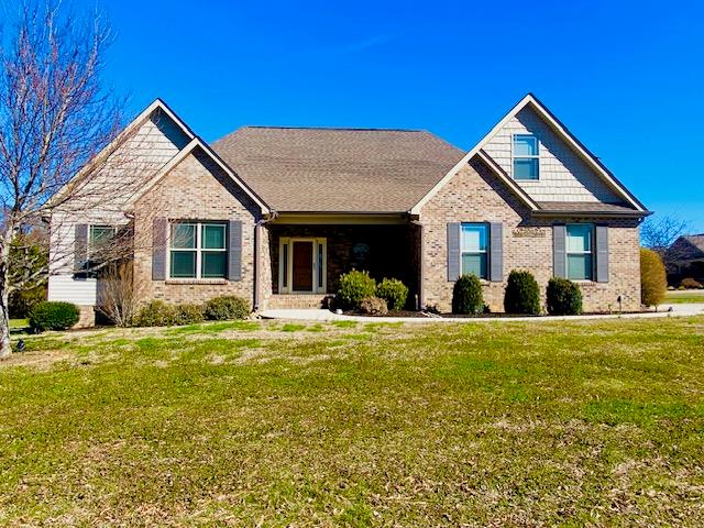 craftsman house featuring a front yard and brick siding