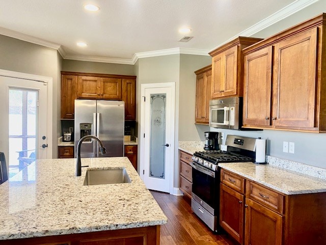 kitchen with appliances with stainless steel finishes, a sink, ornamental molding, and dark wood-style floors