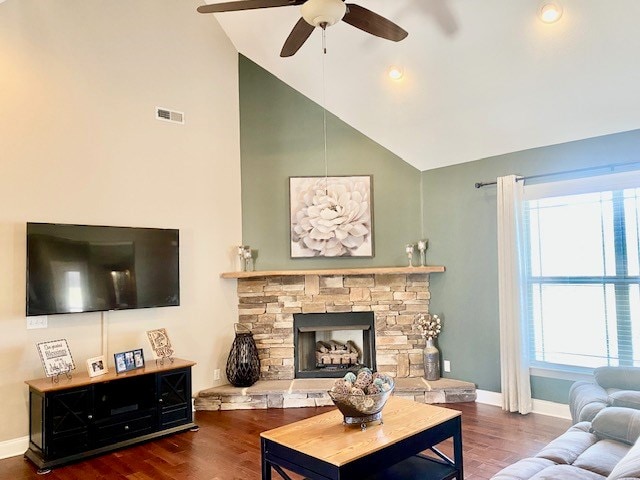 living area with visible vents, a fireplace, baseboards, and wood finished floors