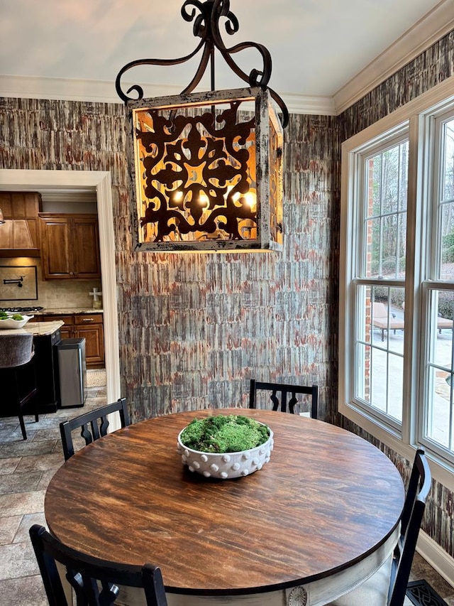 dining room featuring plenty of natural light and ornamental molding