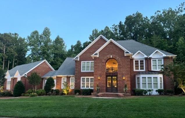 front of property with french doors and a front lawn