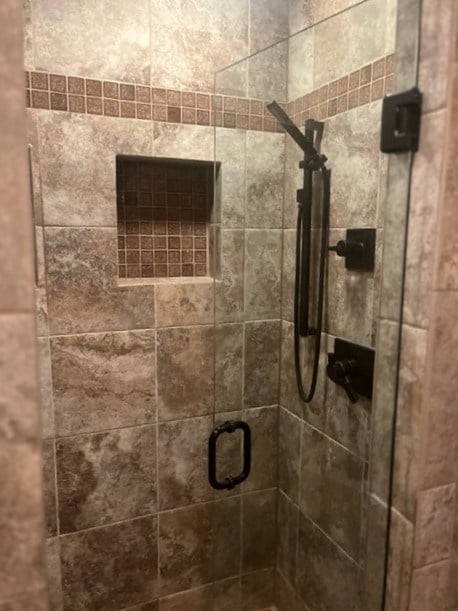 bathroom with a shower with shower door