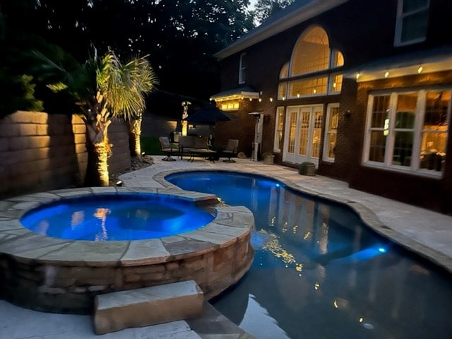 view of swimming pool with an in ground hot tub and a patio