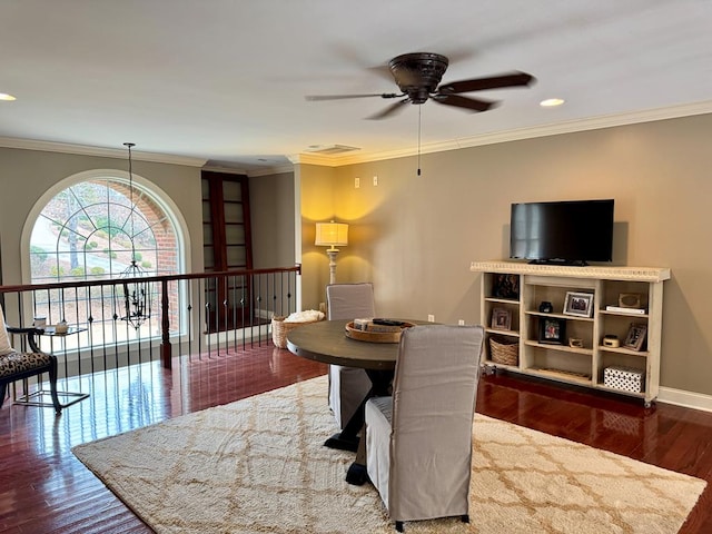 dining area with crown molding, dark hardwood / wood-style floors, and ceiling fan