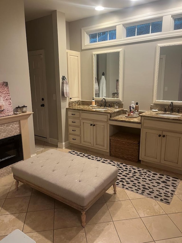 bathroom featuring vanity, a fireplace, and tile patterned flooring