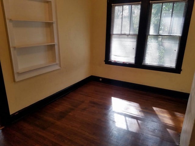 spare room featuring dark wood-type flooring