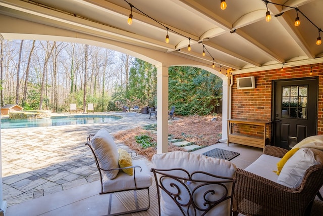 view of patio / terrace featuring an outdoor living space and a pool with hot tub