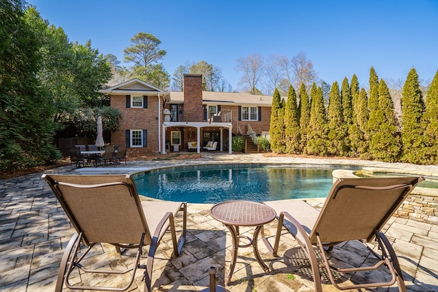 view of swimming pool featuring a patio area