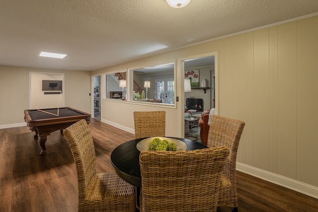 interior space featuring dark wood-type flooring, pool table, and a textured ceiling