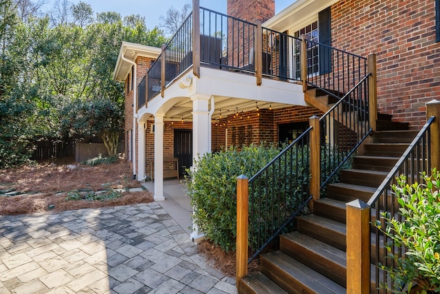 view of exterior entry featuring a patio area