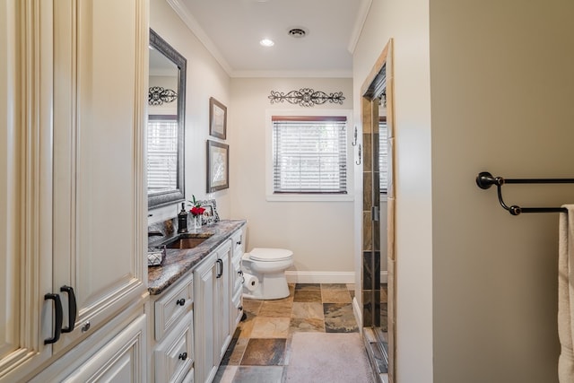 bathroom featuring vanity, crown molding, a shower with door, and toilet