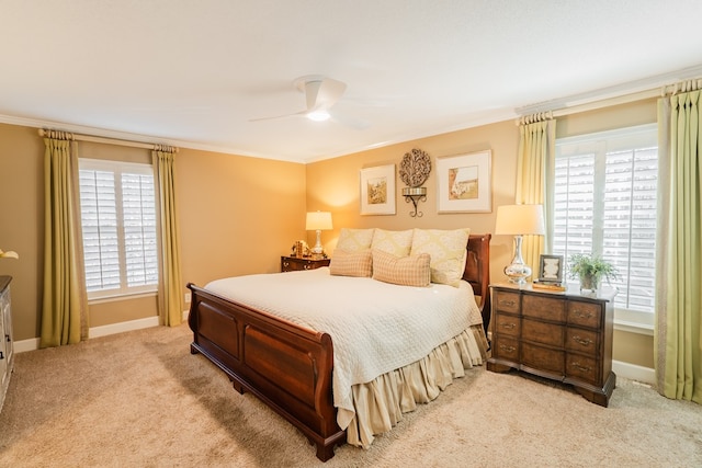 bedroom featuring ceiling fan, ornamental molding, and light carpet