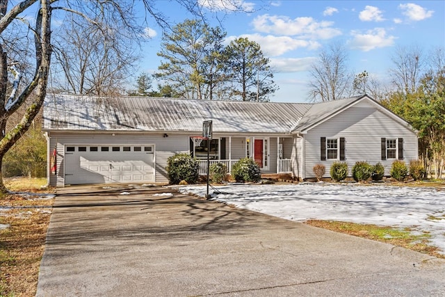 ranch-style home featuring a garage and covered porch