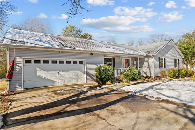 ranch-style house with a garage and covered porch