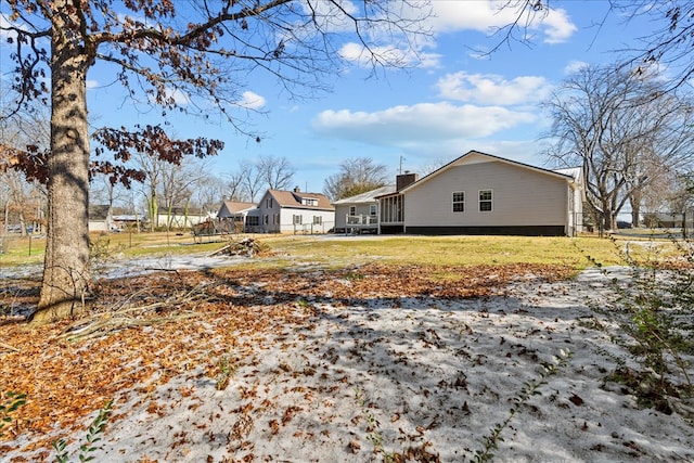 view of side of property with a lawn