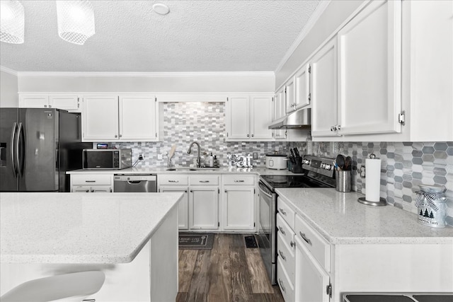 kitchen featuring dark wood-type flooring, sink, ornamental molding, appliances with stainless steel finishes, and white cabinets