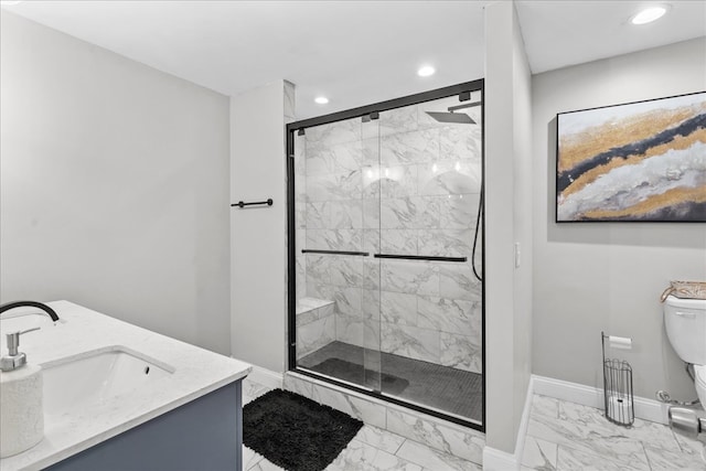 bathroom with vanity, a shower with shower door, and toilet