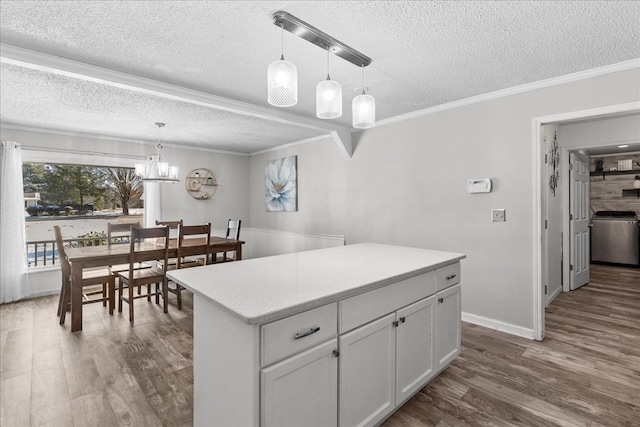 kitchen with white cabinetry, decorative light fixtures, dark wood-type flooring, and a kitchen island