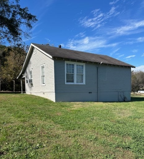 view of side of home featuring a lawn